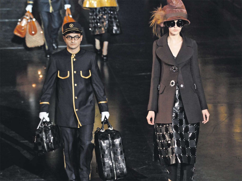 A porter carries a bag at the
Louis Vuitton show