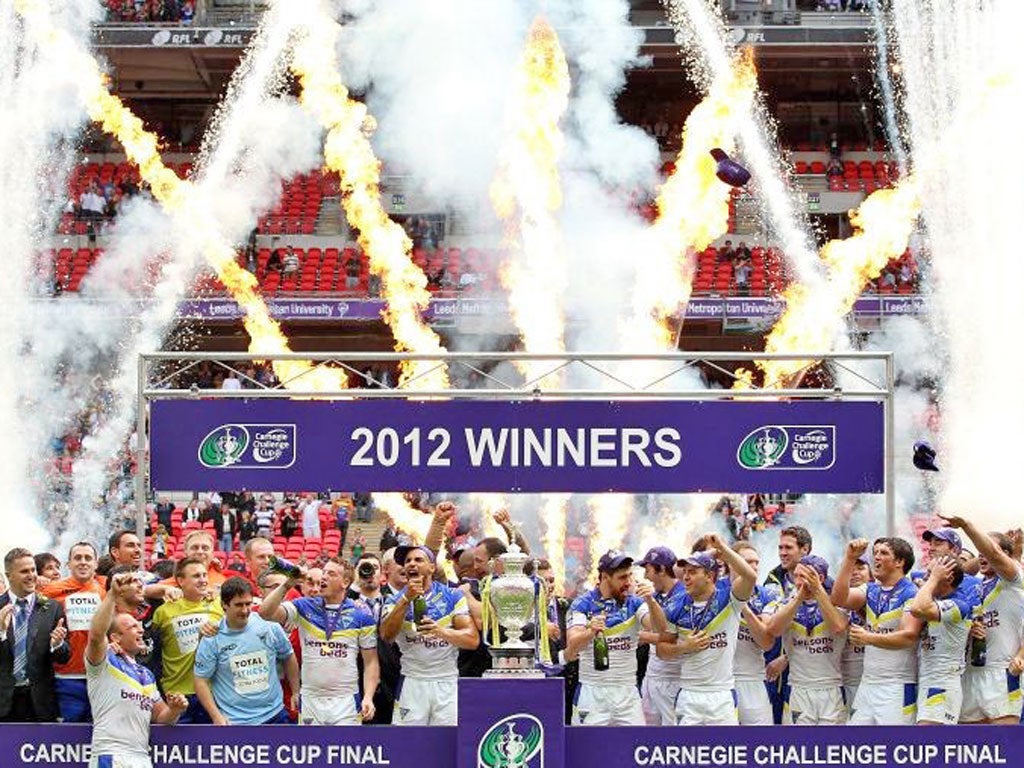Warrington players celebrate with the Challenge Cup trophy after their victory over Leeds Rhinos in the final at Wembley