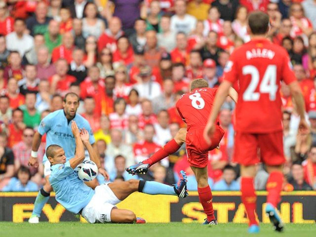 City’s Jack Rodwell handles the ball after a Steven Gerrard shot.
Luis Suarez scored from the subsequent free-kick