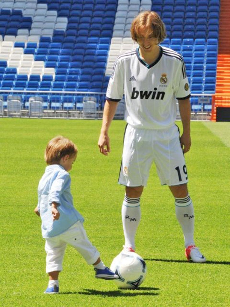 Luka Modric plays with his son during his unveiling at Madrid’s
Bernabeu stadium yesterday