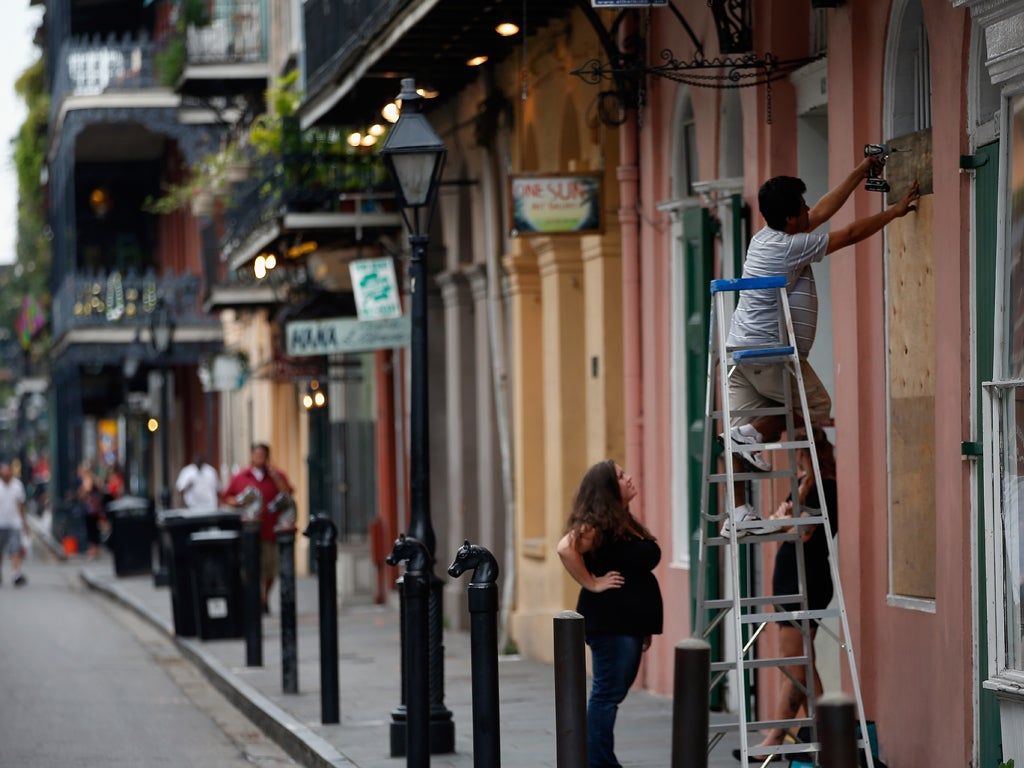 Business owners board up shop fronts in preparation for Isaac's arrival