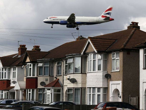 A British Airways jets arrives over the top of houses to land at Heathrow Airport