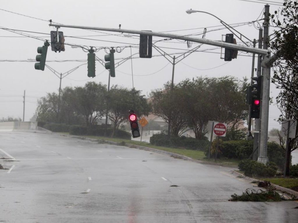 A stop light hangs down during strong wind and rain as Hurricane Isaac pushes into the New Orleans metro area in Metairie