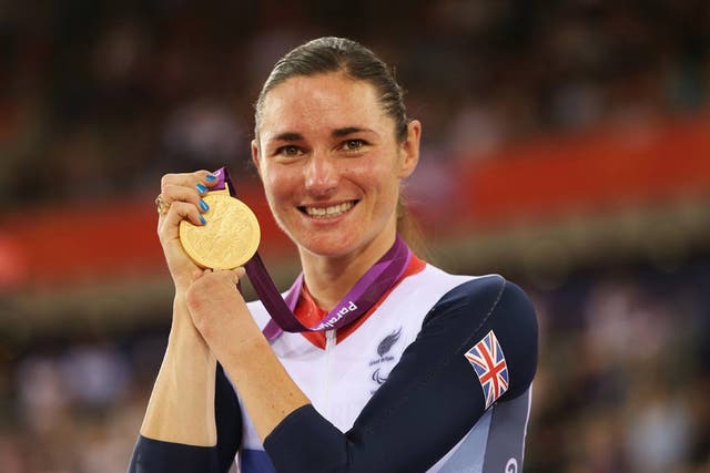 <p>Dame Sarah Storey brandishes one of her many gold medals </p>