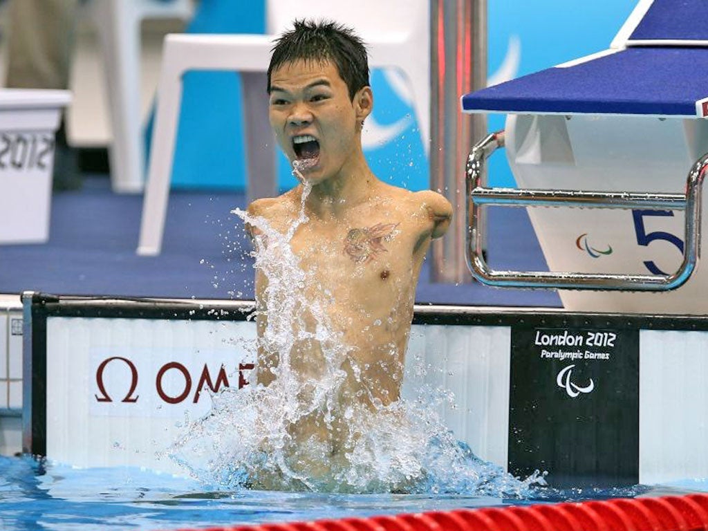 Tao Zheng of China celebrates winning the men’s 100m backstroke