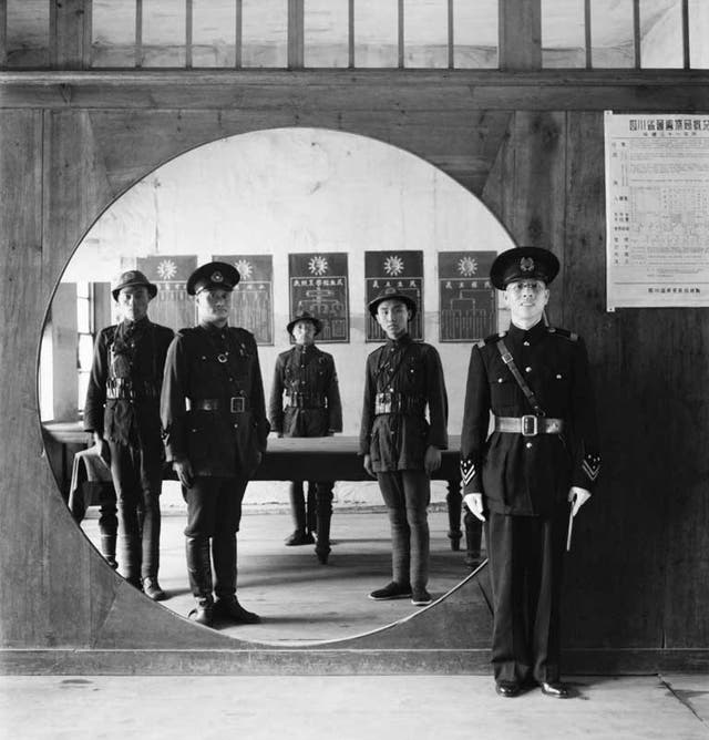 The assistant chief of police and his staff at headquarters in Chengtu, China, 1944