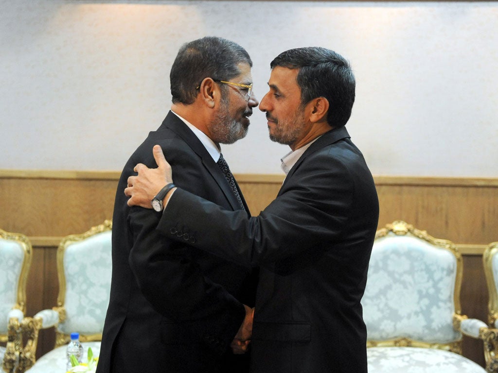 Mahmoud Ahmedinejad's warm welcome for Mohamed Morsi in
Tehran vanished after the Egyptian President got up to speak