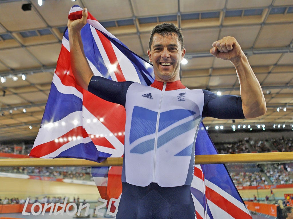 Gold medallist Mark Colbourne proudly holds the Union flag