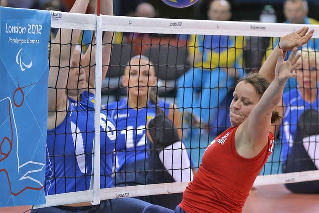 Martine Wright (right) moves to block an attempted Ukraine spike on the sitting volleyball court yesterday