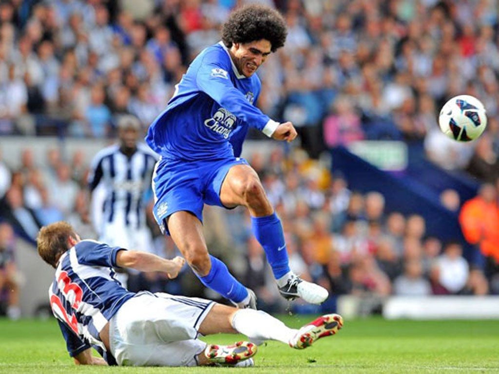 West Bromwich Albion's Northern Irish defender Gareth McAuley, left, vies with Everton's Belgian midfielder Marouane Fellaini, right