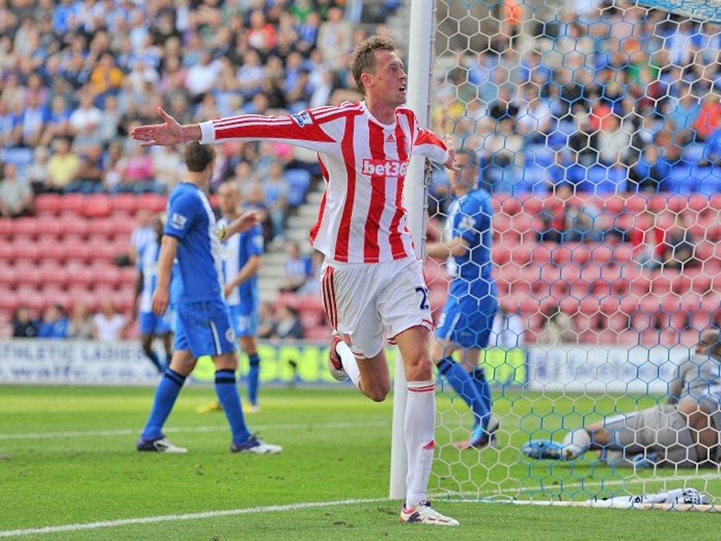 Peter Crouch of Stoke City celebrates scoring his side's second goal against Wigan Athletic