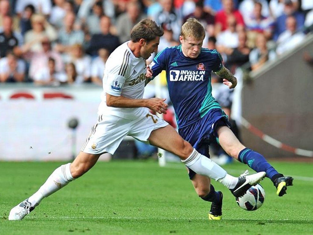 Angel Rangel of Swansea City and James McClean Sunderland battle for the ball at Liberty Stadium