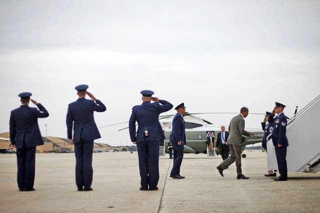 Here he comes: President Barack Obama boards Air Force One to
go campaigning ahead of this week’s Democrat convention