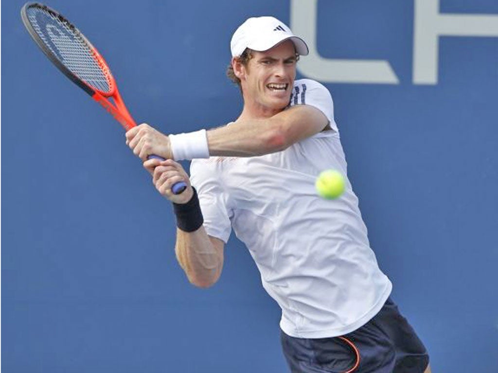 Andy Murray grimaces in the heat of the Louis Armstrong Stadium
on his way to a four set victory over Feliciano Lopez