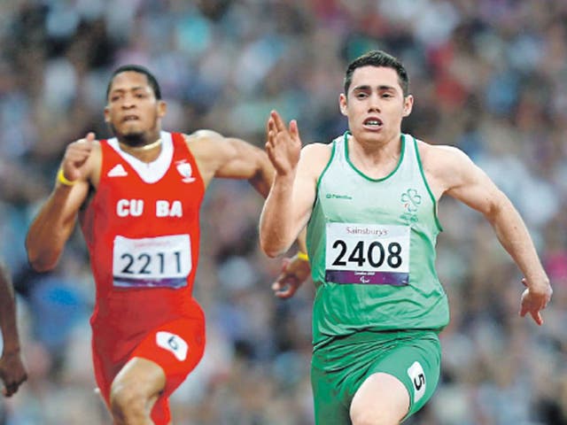 Ireland's Jason Smyth (right) wins the men's 100m T13 final last night