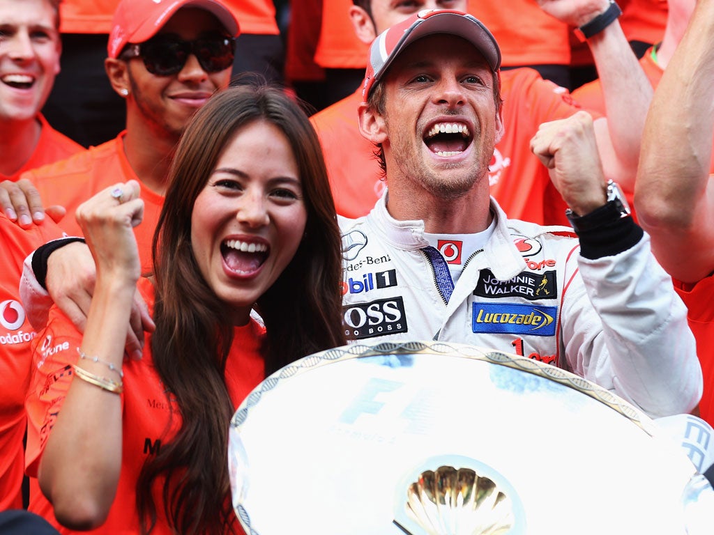 Jenson Button celebrates with his girlfriend, Jessica Michibata
