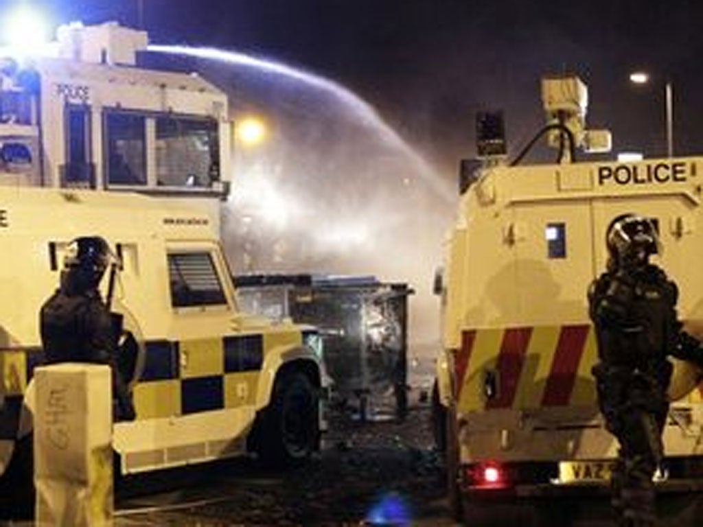 Police use water cannon on loyalist rioters in north Belfast