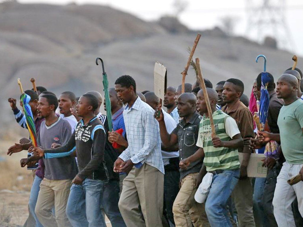 Striking platinum mineworkers protest after negotiations at Lonmin’s Marikana mine