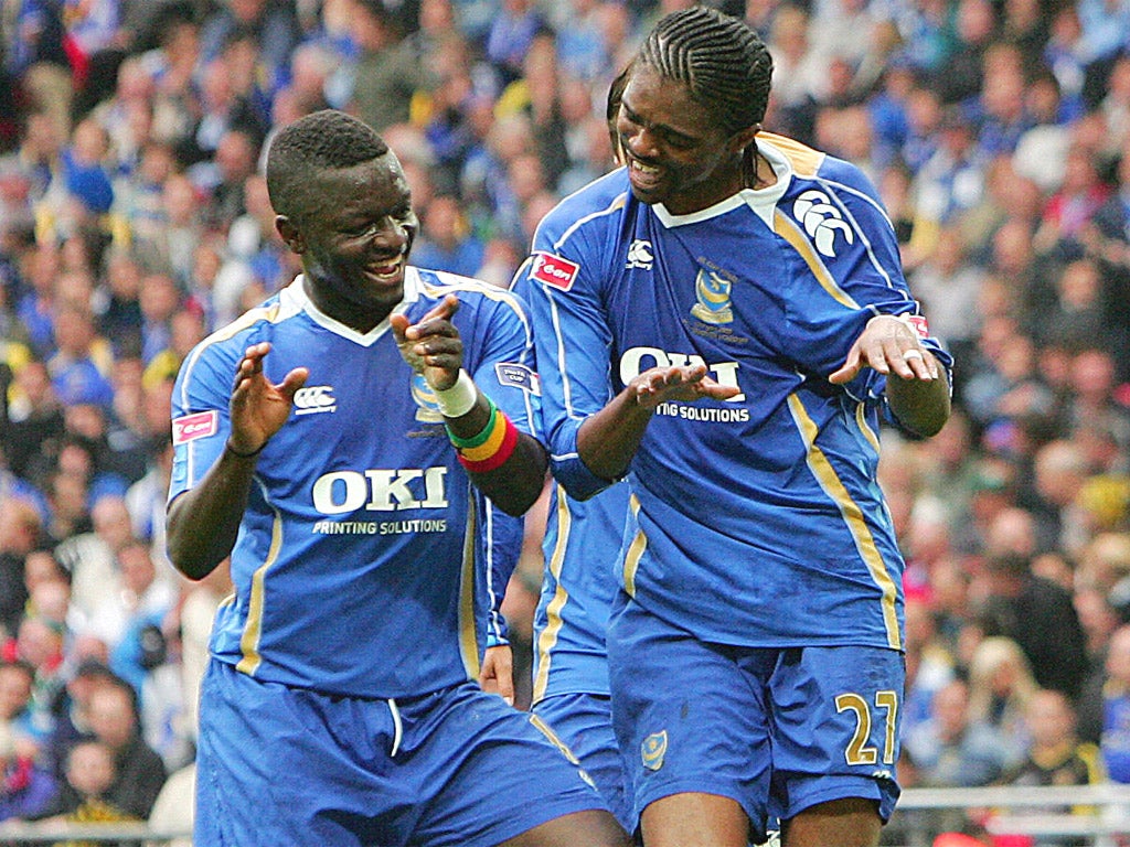 Sulley Muntari (left) and Kanu celebrate better days at Pompey