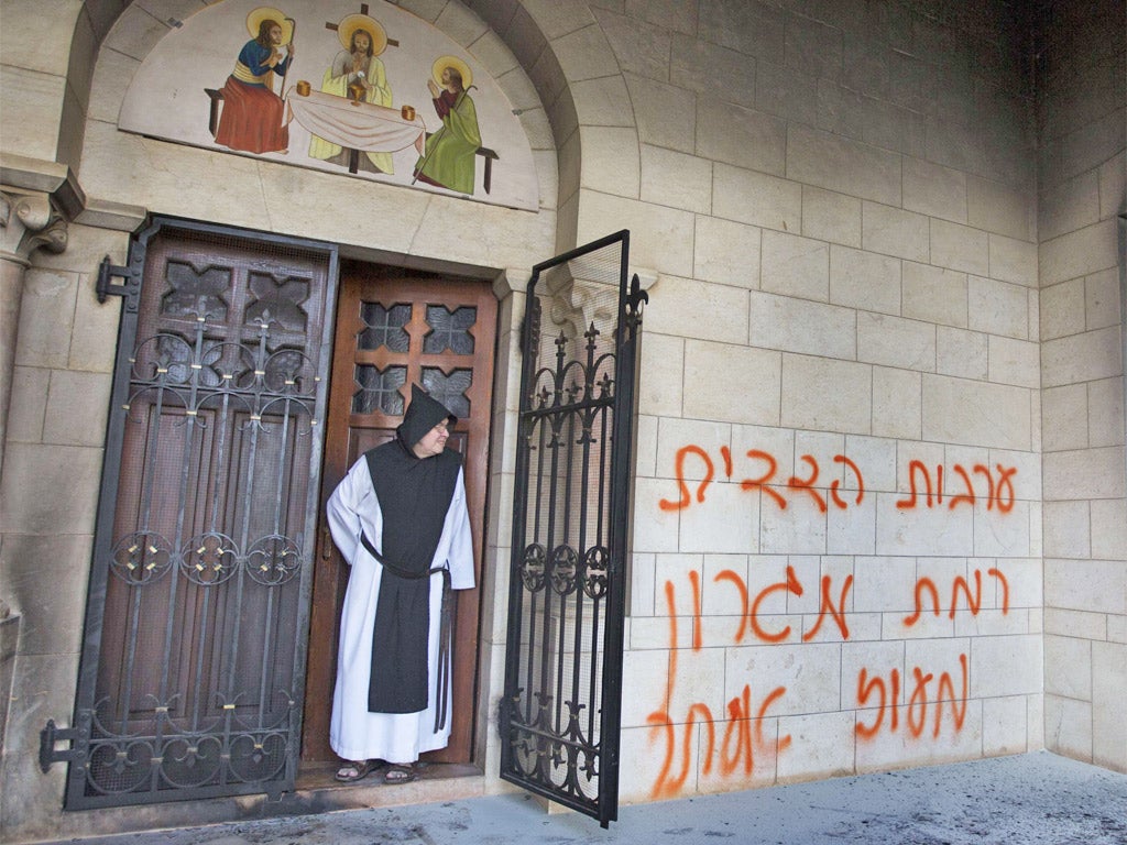 Hebrew graffiti sprayed on the wall of the Latrun monastery