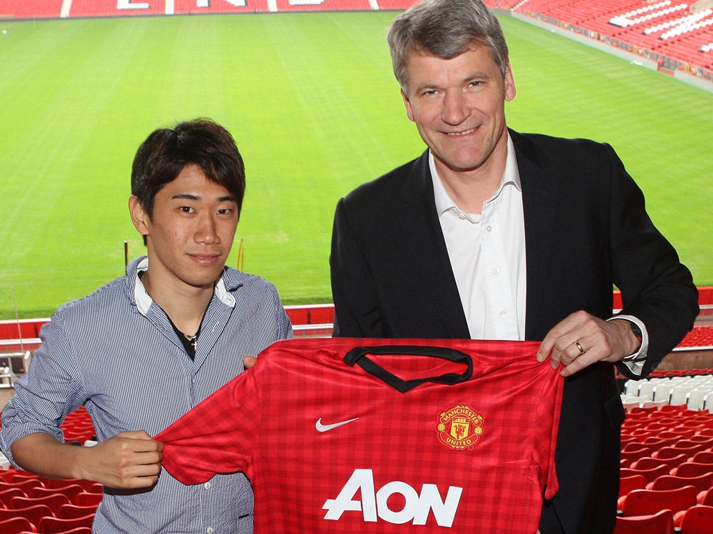 Manchester United chief executive, David Gill, poses with Shinji Kagawa, one of the club's summer signings