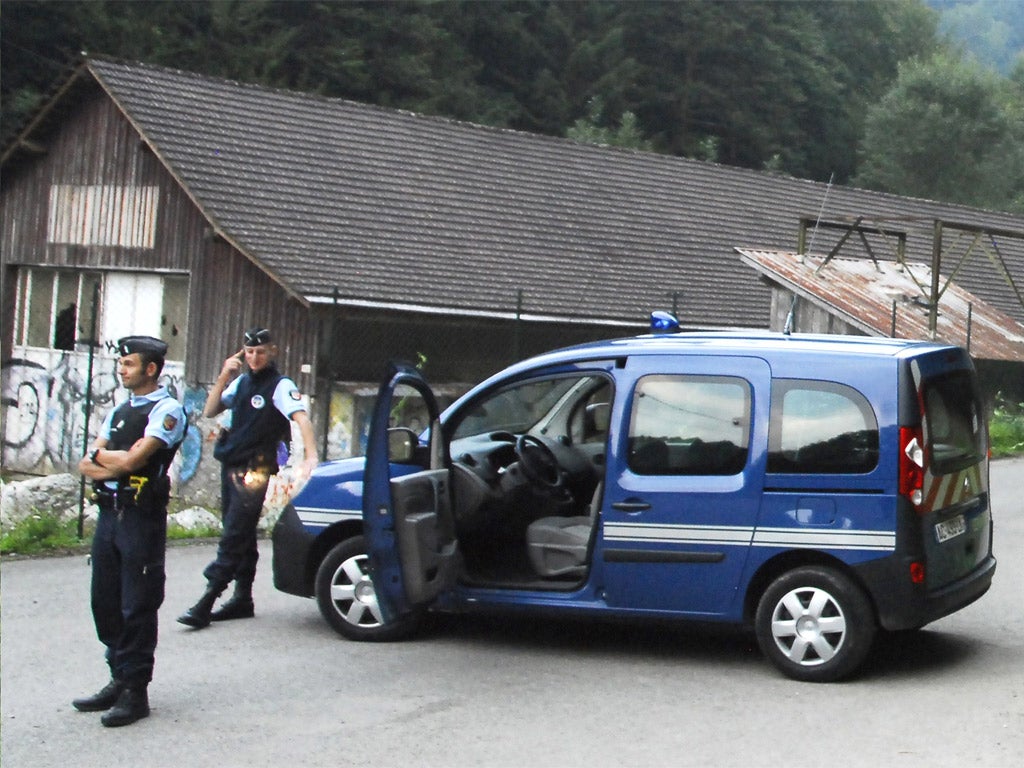 French police block the road to the murder scene near Lake Annecy in eastern France