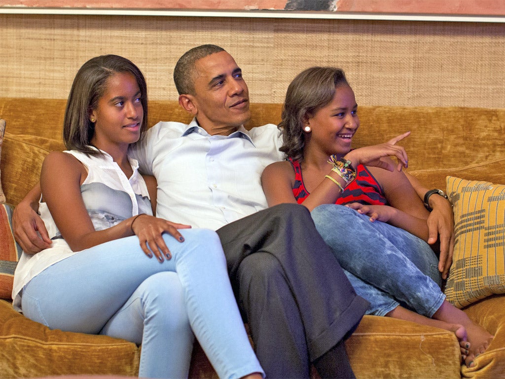 Barack Obama and his daughters, Malia, left, and Sasha watch the First Lady deliver her speech on Tuesday night