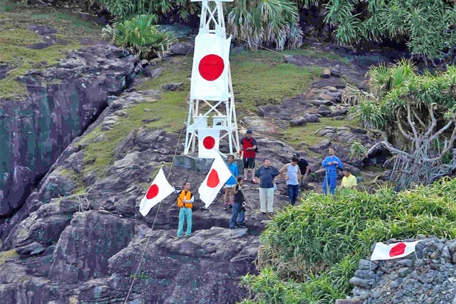 Japanese nationalists and surveyors on a disputed island in the East China Sea, known as Senkaku in Japanese and Diaoyu in Chinese