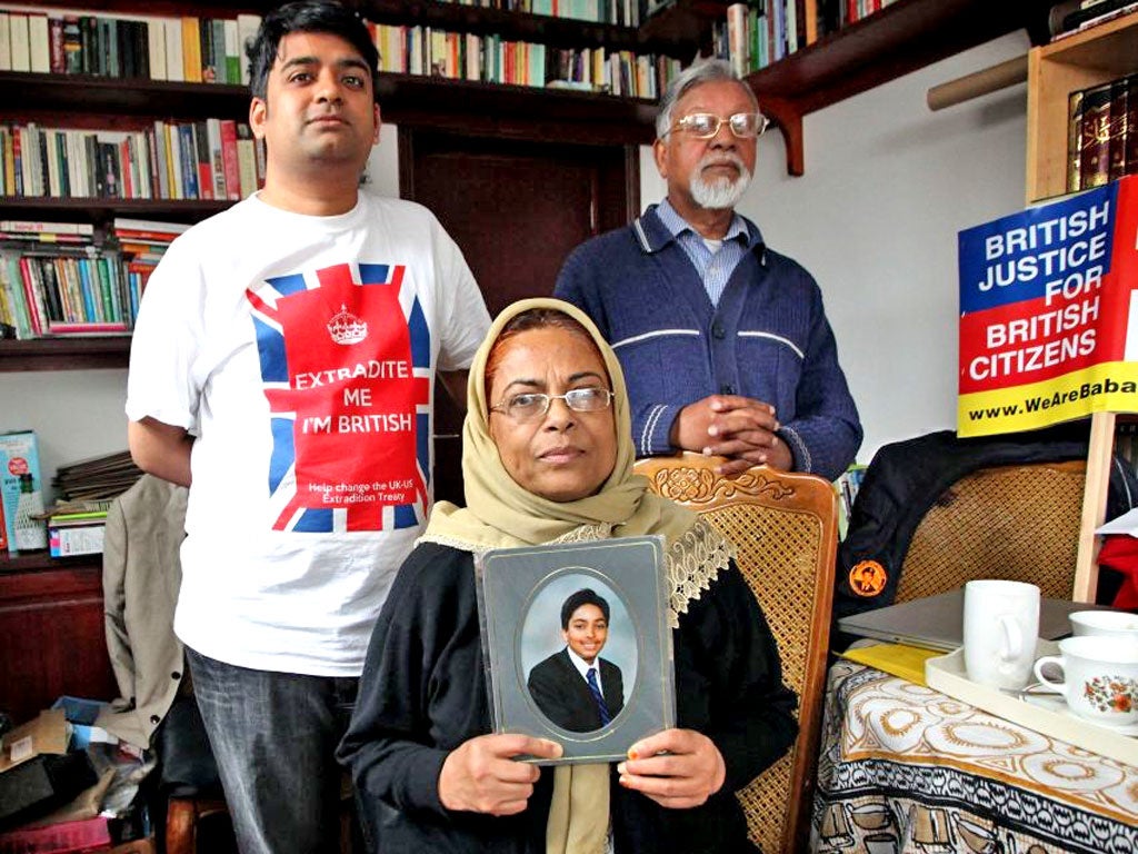 The family of Talha Ahsan, pictured with a photograph of him aged 12 at their home in London
