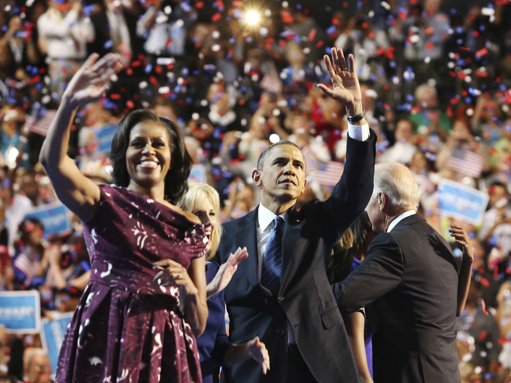 Barack and Michelle Obama wave to the crowd during the final session of the Democratic National Convention in Charlotte