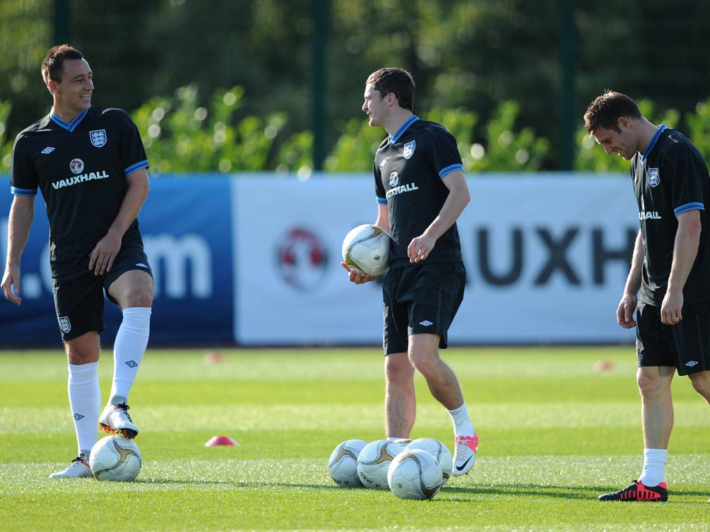 England defender John Terry (left), midfielder Adam Johnson (centre) and midfielder James Milner