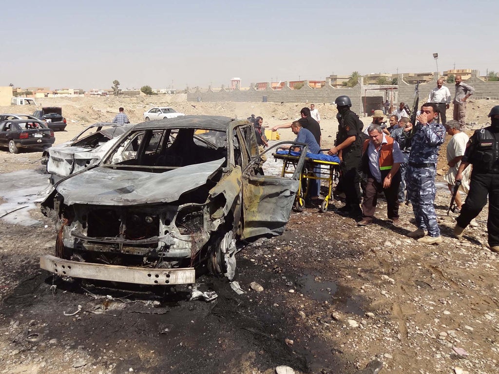 Iraqi security forces and rescue workers inspect the site of the blast in the northern Iraqi city of Kirkuk