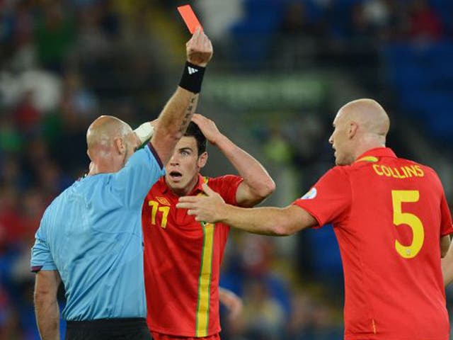 Wales' James Collins is shown a red card