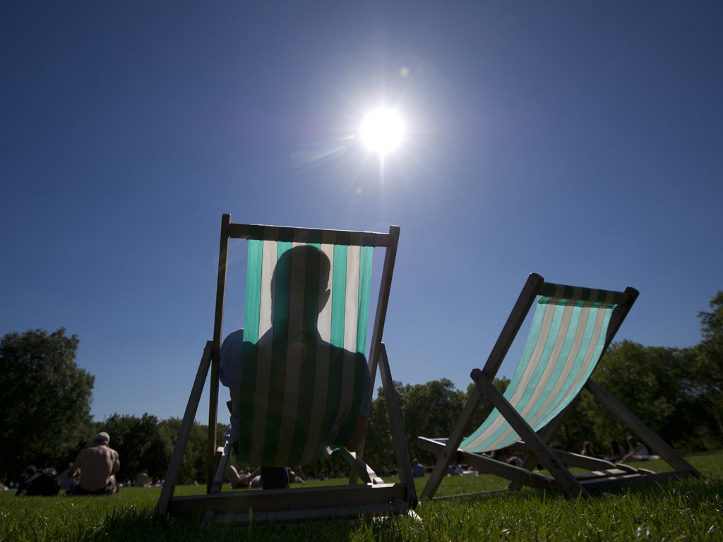 A man soaks up the sunshine in central London yesterday