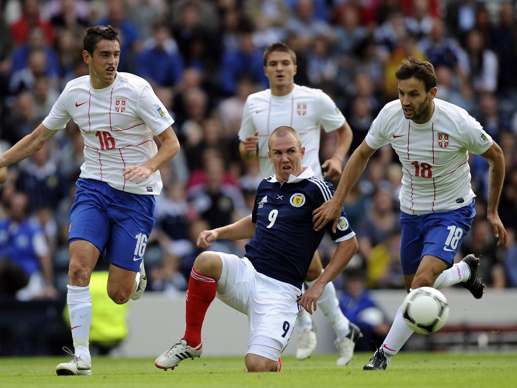 Gone again: Kenny Miller sees the ball get away from him during a disappointing Scottish display at Hampden Park