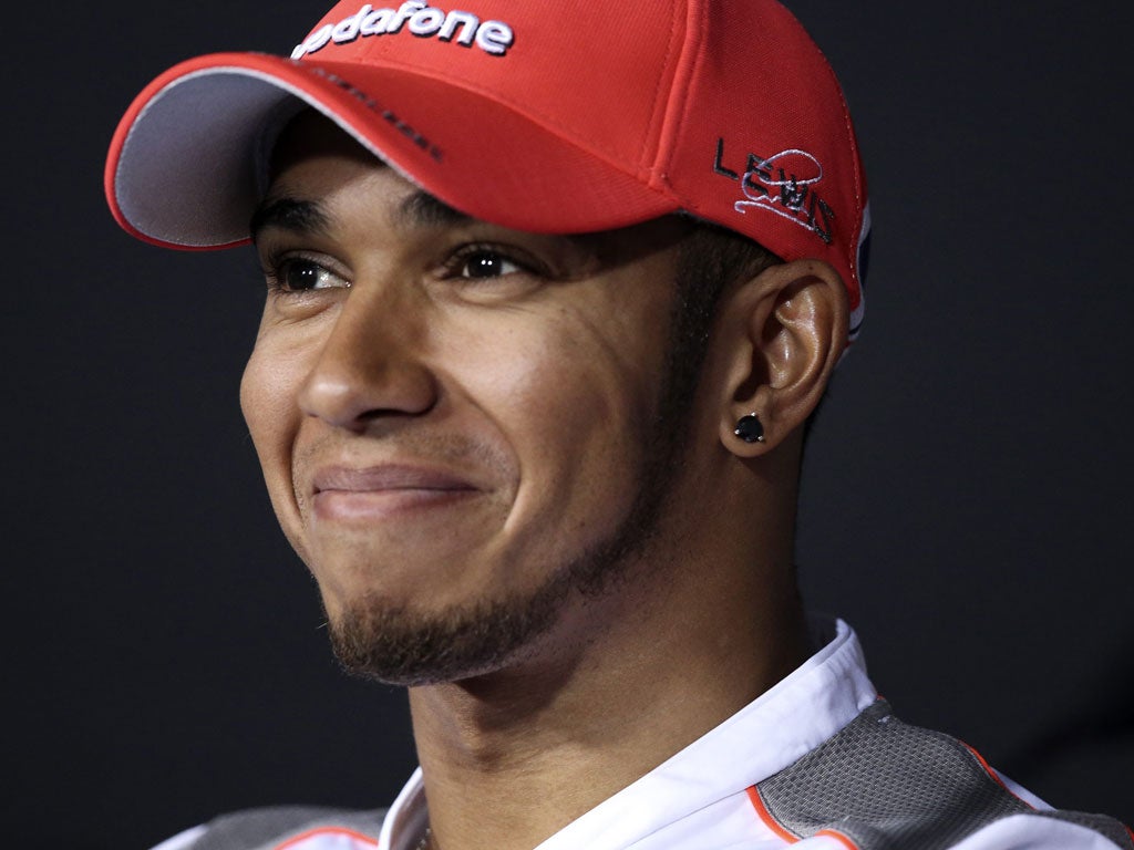 Force a smile: Hamilton is quickest but feels he could have done better
