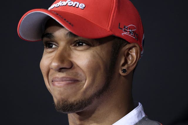 Force a smile: Hamilton is quickest but feels he could have done better