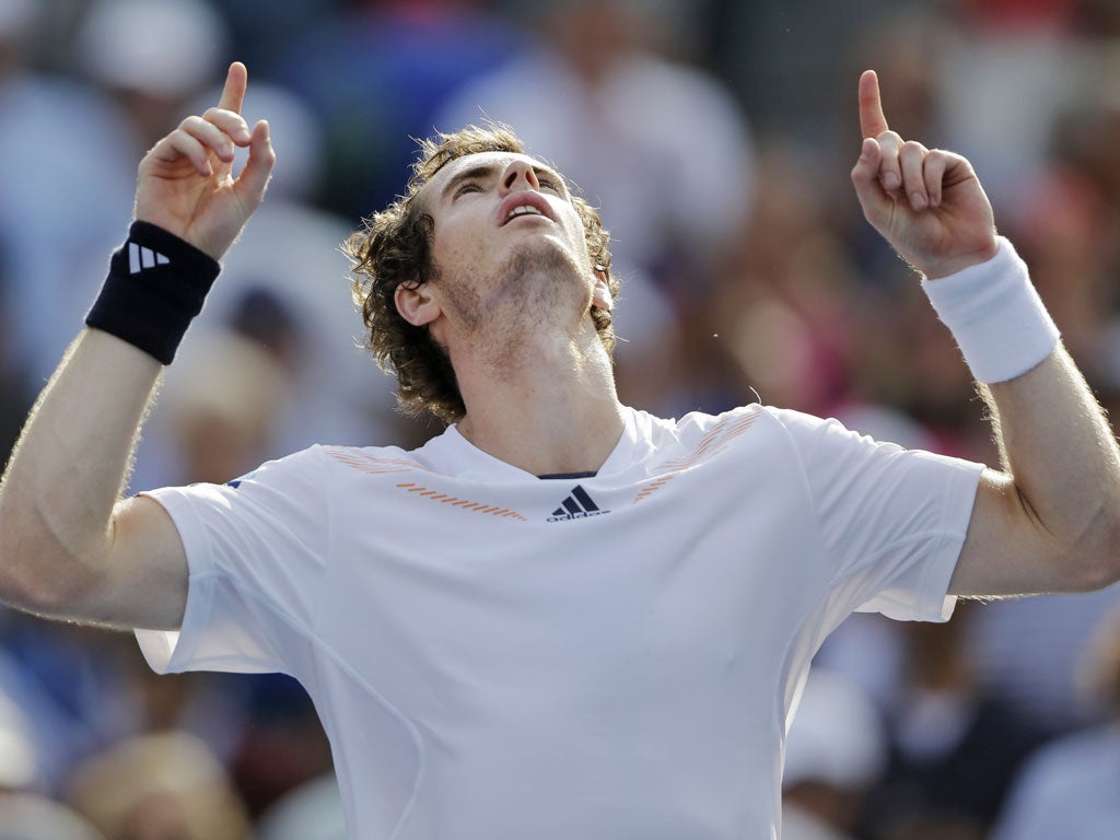 Andy Murray looks to the stormy skies as he celebrates his four-set victory over Tomas Berdych at Flushing Meadows last night after a match which was played in high winds