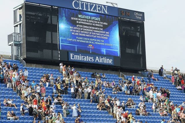 The scoreboard shows a weather warning as fans head to the exits on Saturday