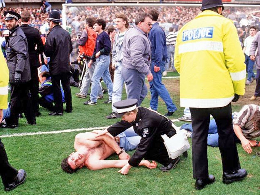 Fans and emergency personnel on the pitch at Hillsborough on the
day of the disaster in April 1989