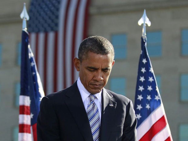 Barack Obama observes a moment of silence on the 11th anniversary of the 9/11 attacks