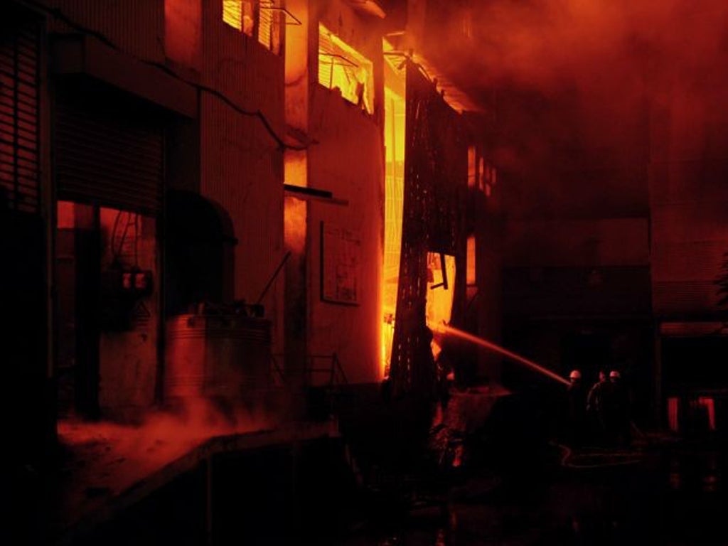 Firefighters battle the blaze at one of the factories in Karachi