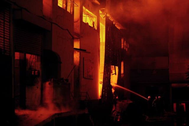 Firefighters battle the blaze at one of the factories in Karachi