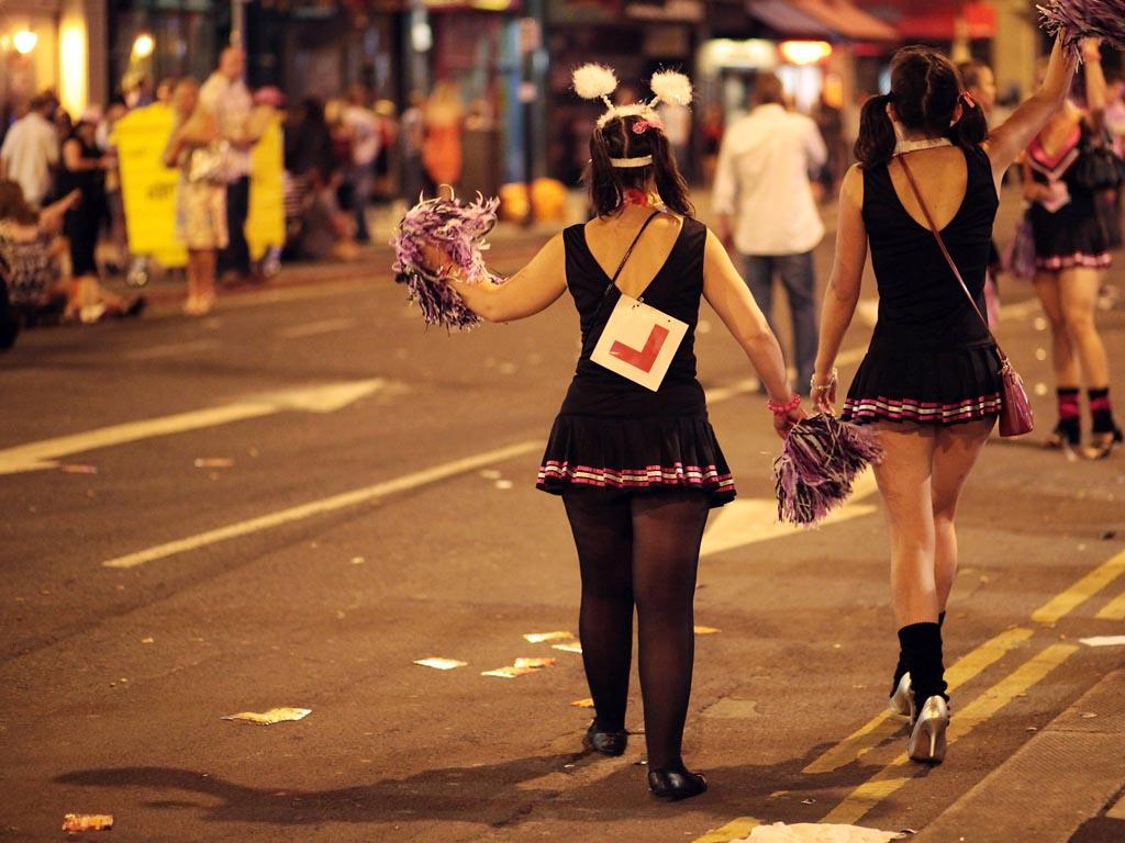 Girls wearing fancy dress walk between the various pubs and clubs in Cardiff city centre