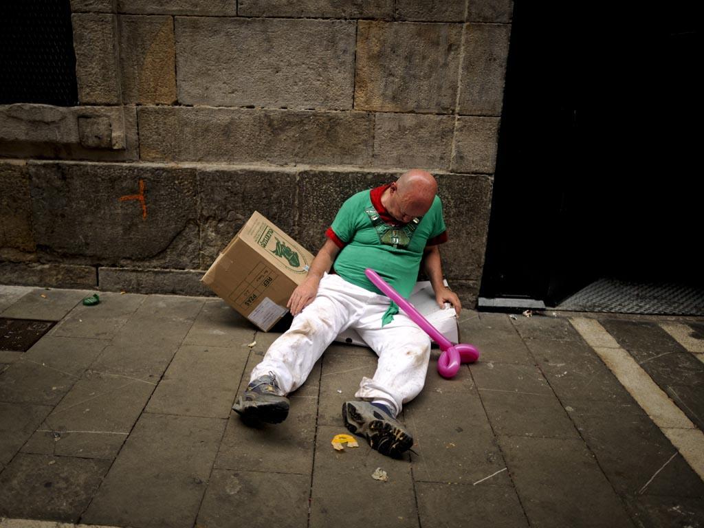 A drunk man sleeps on the street