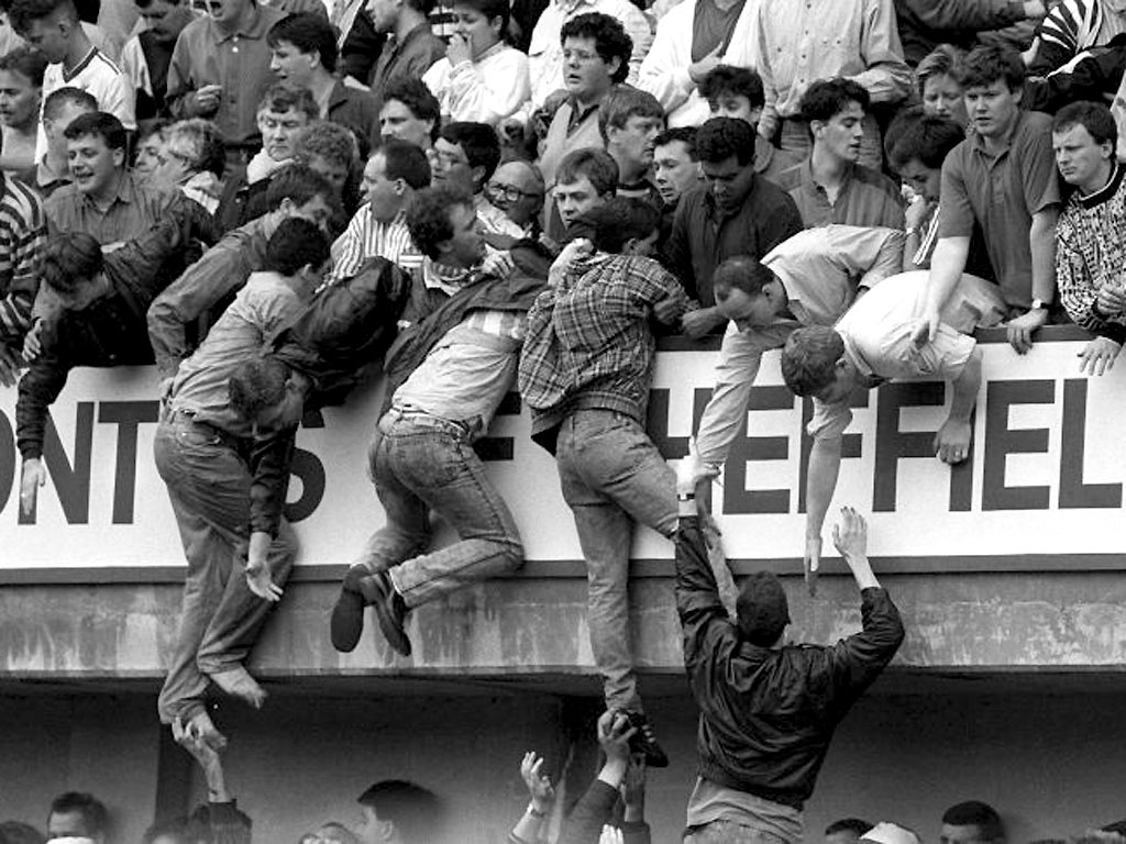 15 April 1989: Liverpool fans trying to escape severe overcrowding during the FA Cup semi-final football match between Liverpool and Nottingham Forest at Hillsborough
