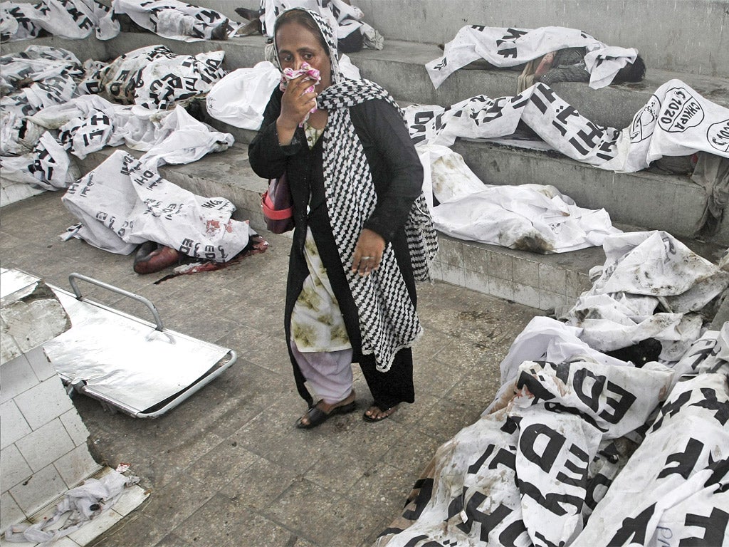 A woman looks for her missing family member at a morgue in Karachi