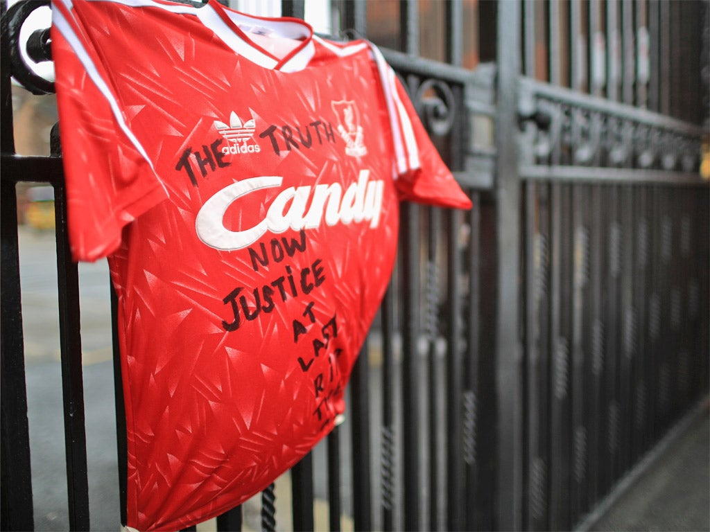 A Liverpool shirt with the message 'The Truth Now Justice At Last, RIP The 96' is tied to the Shankly gates at Anfield stadium