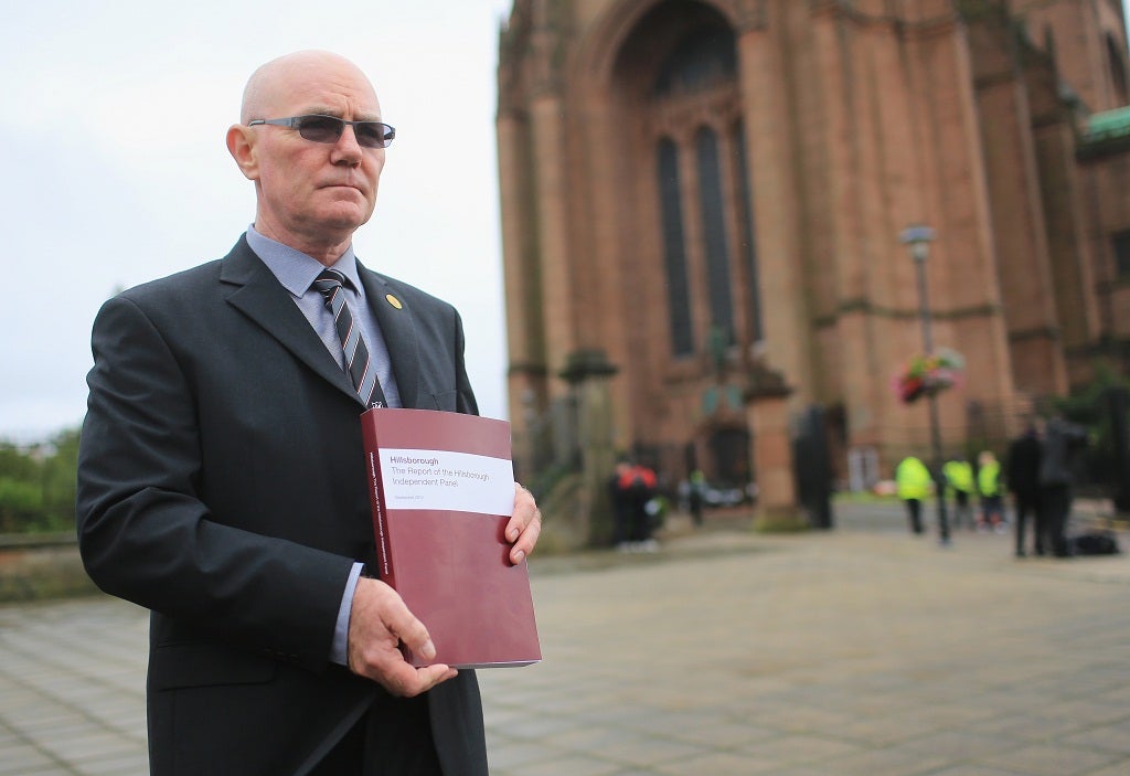 Steve Kelly of the Hillsborough Justice Campaign poses outside Liverpool Anglican Cathedral with his copy of the independent report into the 1989 Hillsborough Disaster on September 12, 2012 in Liverpool, England.