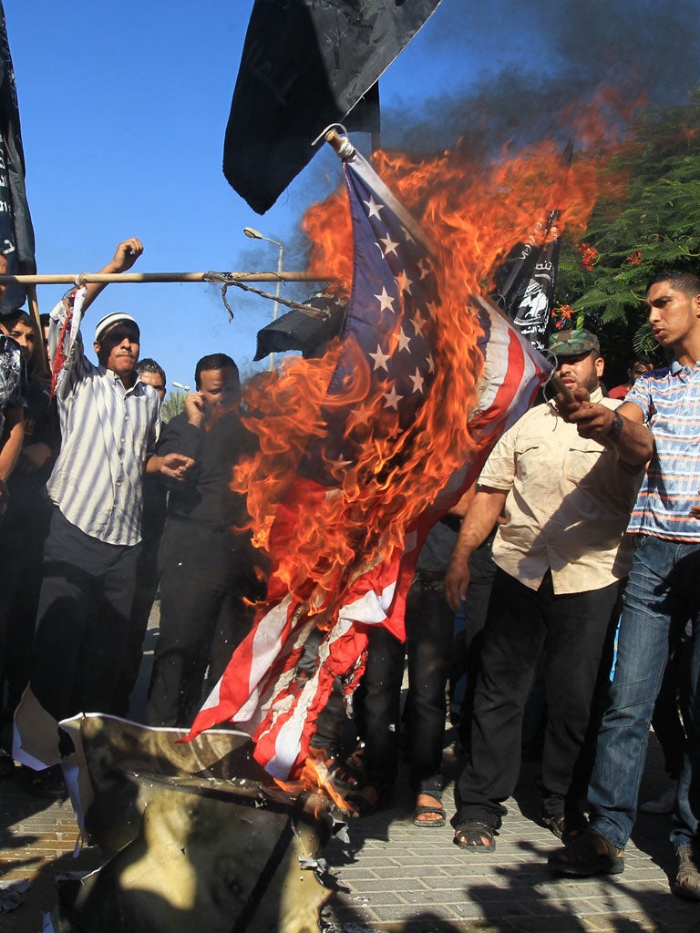 Islam's Fury: Palestinian men burn the US flag in front of the United Nations HQ in Gaza City last week